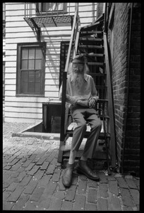 Prescott Townsend: full-length portrait seated on a fire escape on Beacon Hill