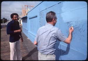 Bill Withers: Withers laughing with a man cleaning graffiti