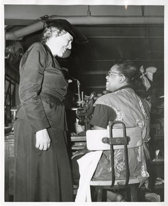 Mary Switzer speaks with a trainee at work at the Institute for the Crippled and Disabled