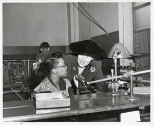 Mary Switzer speaks with a woman at work at the Institute for the Crippled and Disabled