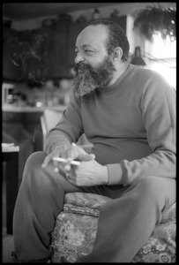 Andrew Salkey: three-quarter length portrait seated, with cigarette