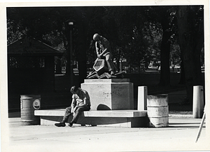 Man seated by Parkman Plaza Industry Sculpture, Boston Common