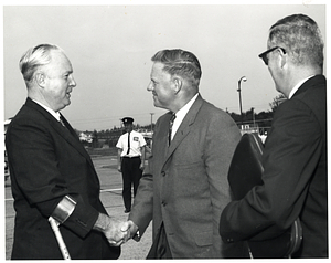 Mayor John F. Collins shakes hands with Saint John Mayor Dr. Stephen H. Weyman at airport