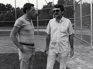 Mayor Raymond L. Flynn and an unidentified man standing on a baseball field