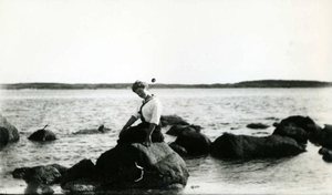 Marie A. Barry as a young woman atop rock in Quissett Harbor