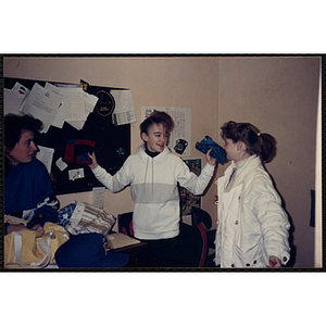 Three girls talking in front of a bulletin board at the Charlestown Boys & Girls Club