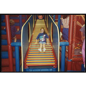 A girl plays in a Chuck E. Cheese's playground