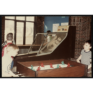 Two boys play table hockey