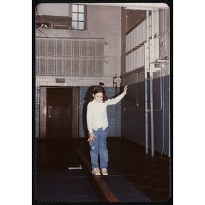 A girl stands on one leg on a balance beam at the Charlestown gymnasium