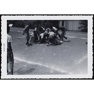 A group of boys play a game outdoors during Tom Sawyer Day