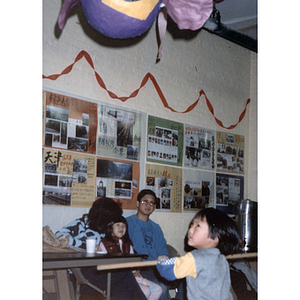 Guest swings at a piñata during the Chinese Progressive Association's children's party