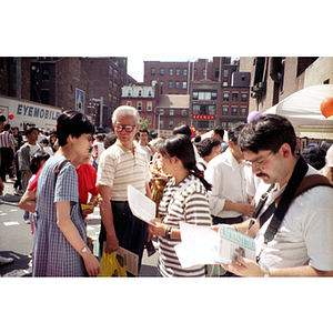 Woman distributes fliers at the August Moon Festival