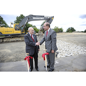 Dr. George J. Kostas and President Joseph E. Aoun shake hands at the groundbreaking site