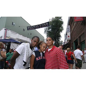 Michael Toney, Melanie Arvajo, and Danny Vazquez pose together outside Fenway Park