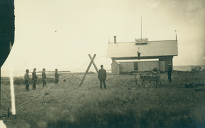 Men hoisting a man up to a rooftop look-out station with rope and pulley, Life Saving Station, Biddeford Pool, Me.