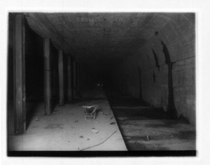 View of interior of Broadway station, showing steel columns and a wheelbarrow