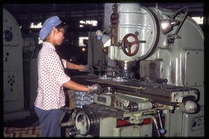 Shanghai tractor building factory: woman operating a machine
