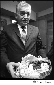 Cambridge Narcotics officer Duncan MacNeil displaying a tinfoil-wrapped package of drugs