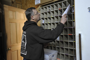 Rick Oliver sorting mail in the post office at the New Salem General Store