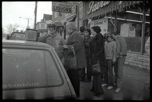 Crowd gathered about a radio perched on the hood of a car in Highland Falls, N.Y., listening to news of the arrival of the hostages from Iran