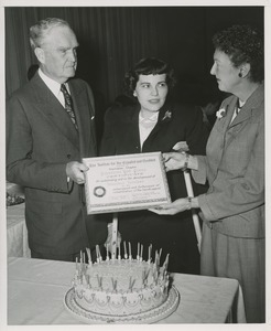 Woman using crutches receives certificate