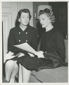 Two women holding pieces of paper