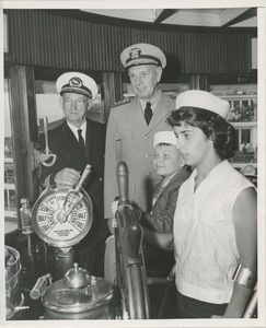 Young boys and woman in wheelhouse