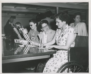 Women with disabilities sit at table