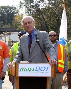 Congressman John W. Olver at the podium, speaking at a MassDOT event