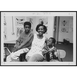 Woman smiling with two young children