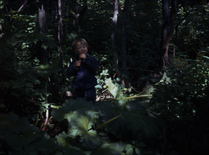 Andrew Art chewing rhubarb (Rheum rhabarbarum) in pre-renovated Buxton Garden.
